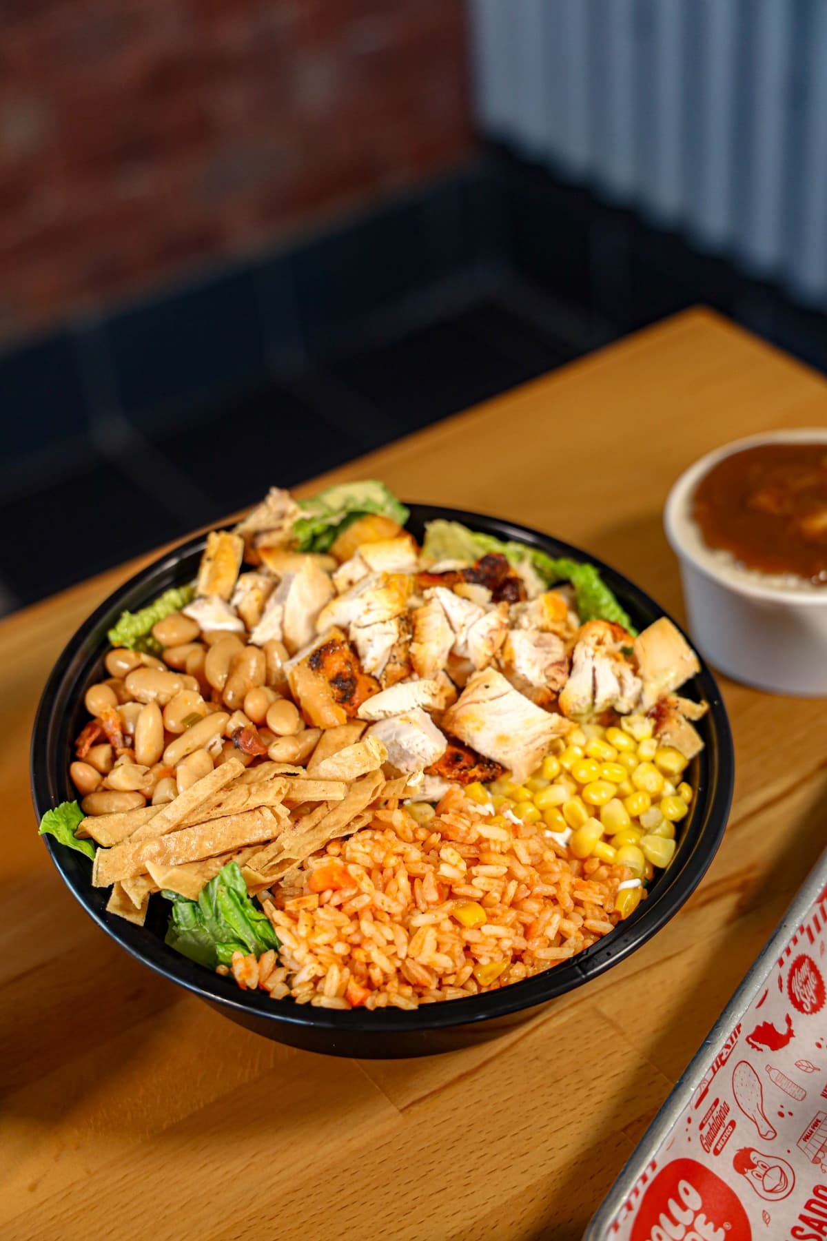 Chicken bowl with fire-grilled chicken, rice, beans and fresh toppings