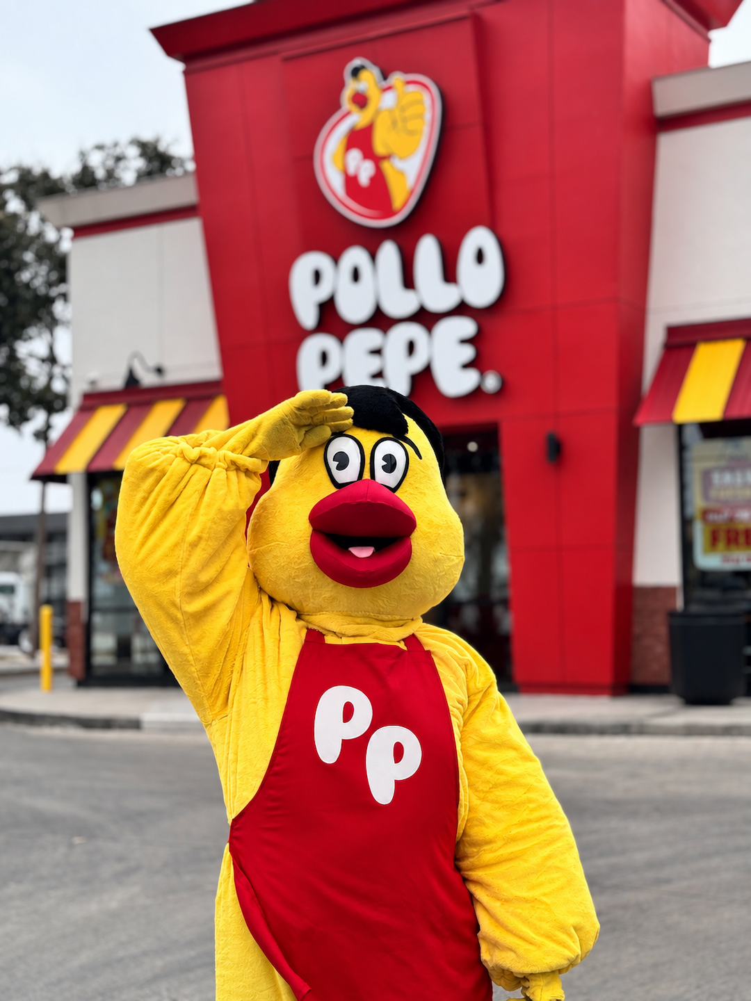 Pepe the mascot saluting outside the Pollo Pepe restaurant on Rittiman Road