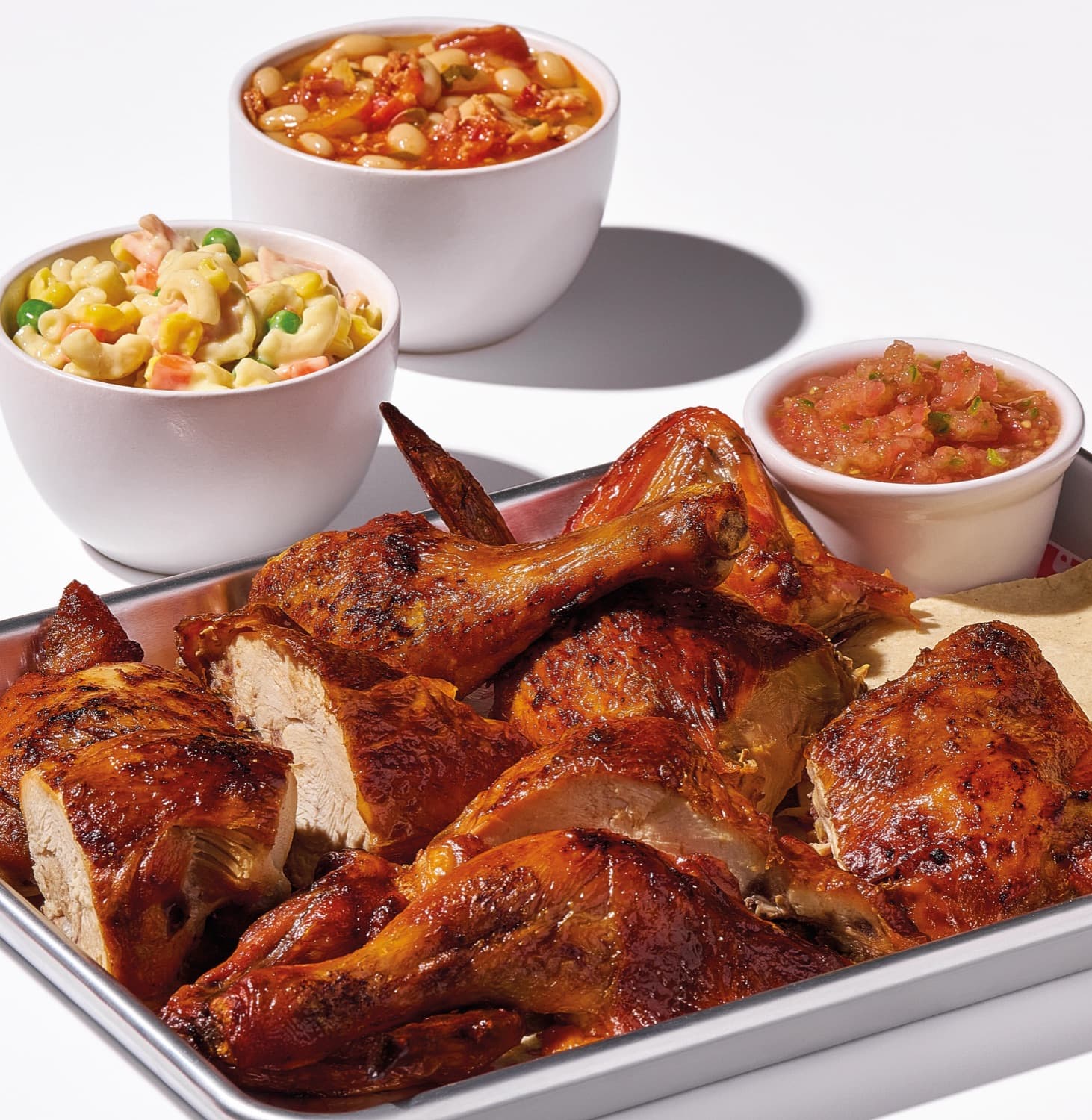 Tray of pollo asado with macaroni salad, charro beans and salsa